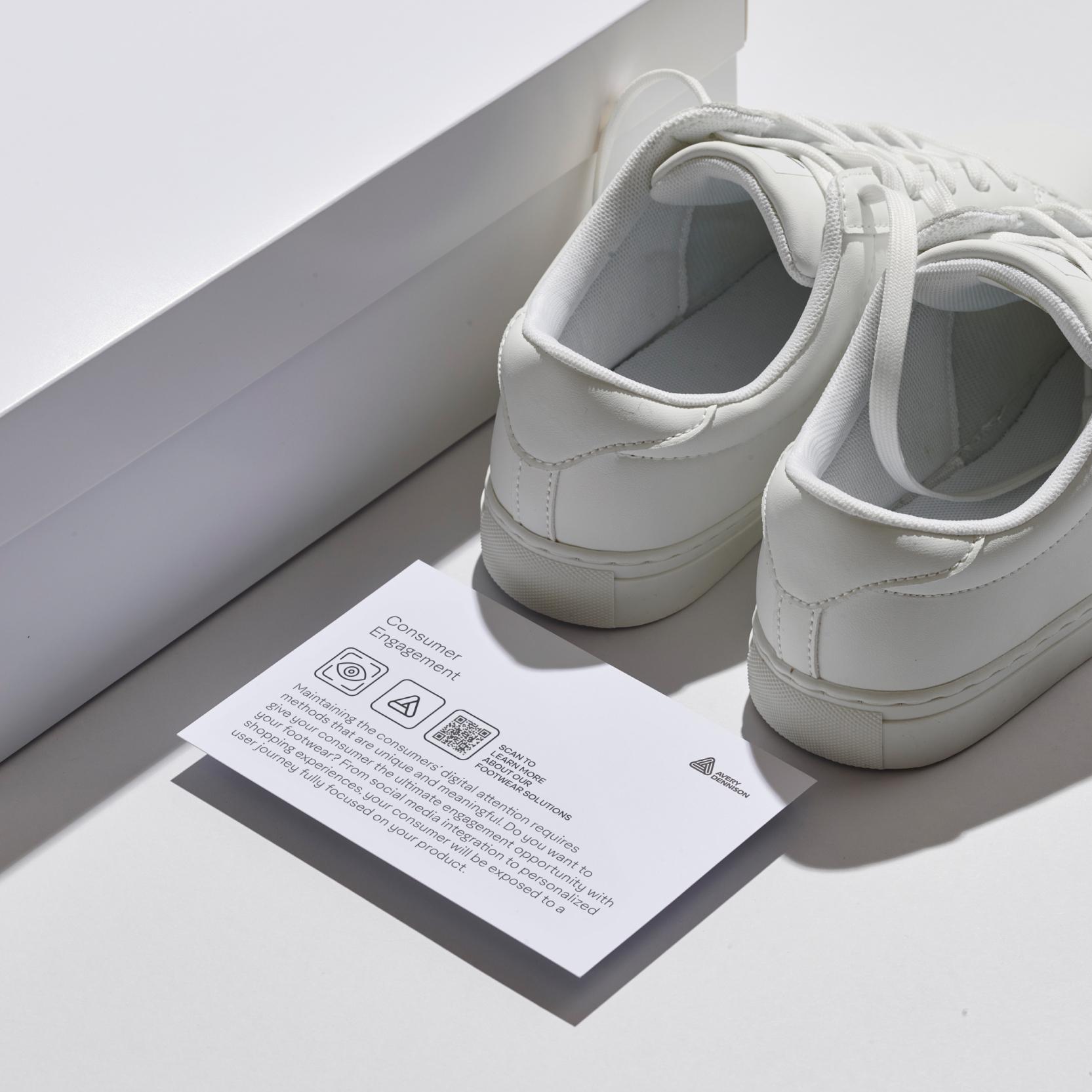 sneakers outside of shoe box with consumer engagement postcard