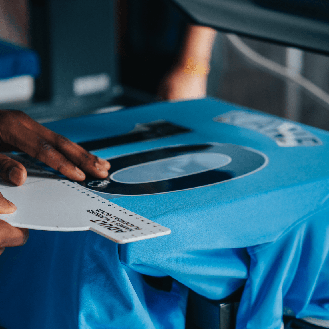 Embelex customization adding names and numbers to sport jersey on a heat press