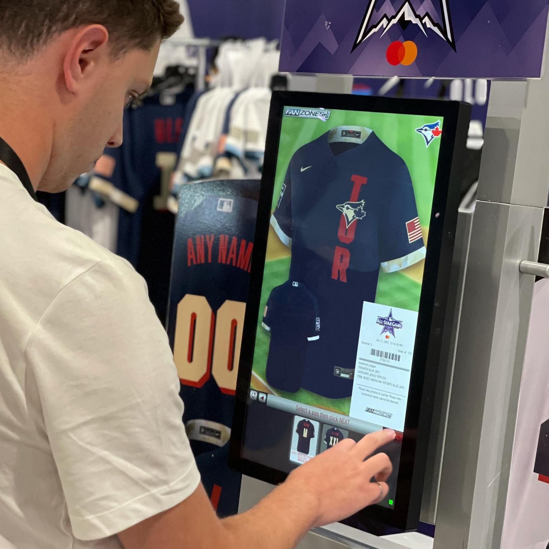 fan using a digital screen to customize sport jersey