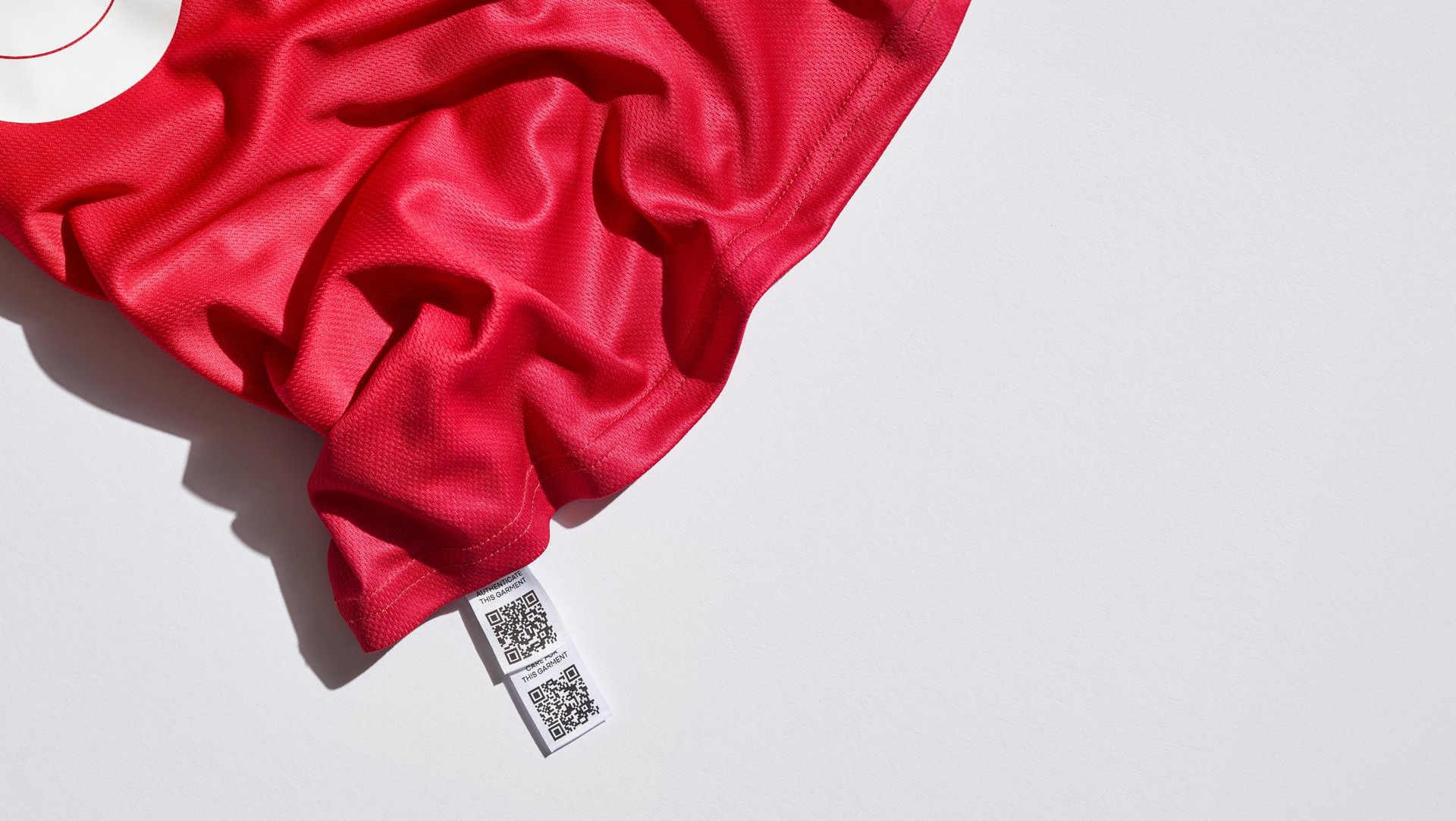 Connected jersey with layered interior labels with QR codes