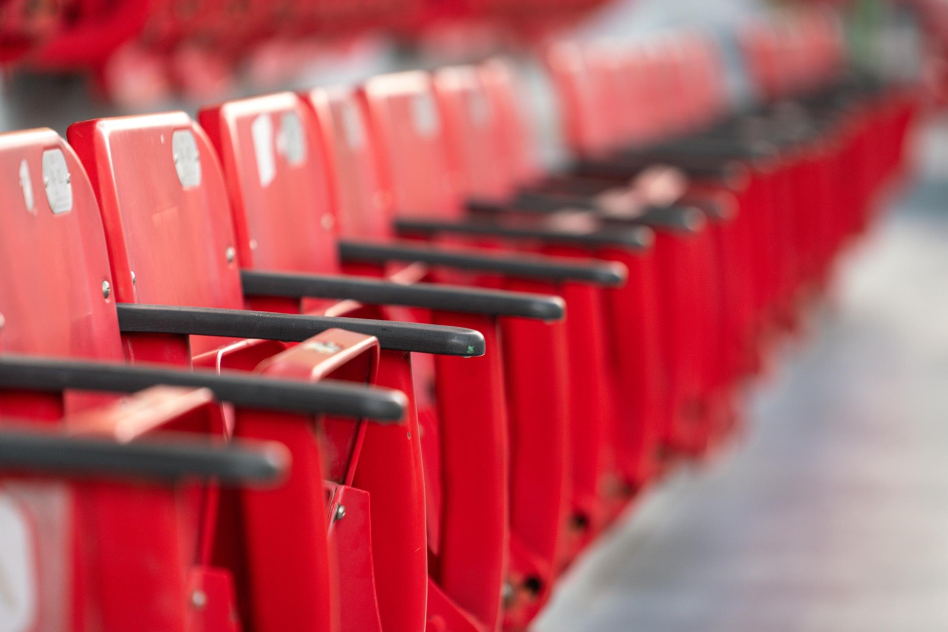 row of red empty stadium chairs at sports arena